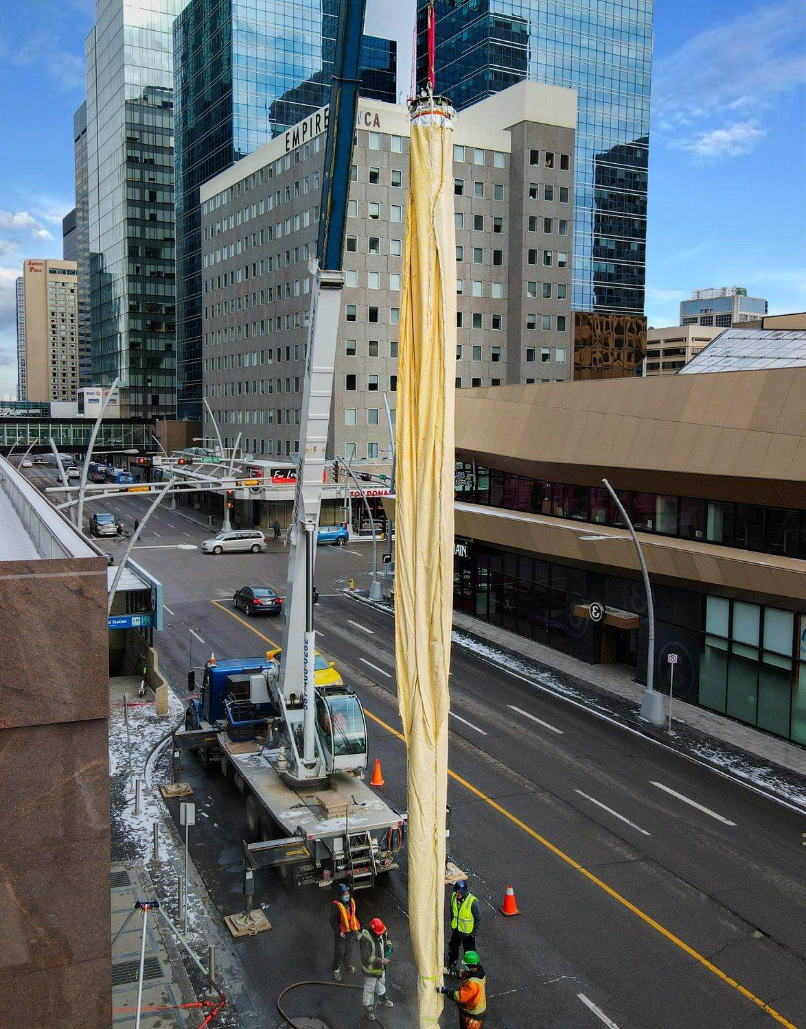 A Triplex Liner being set by crane on a downtown street