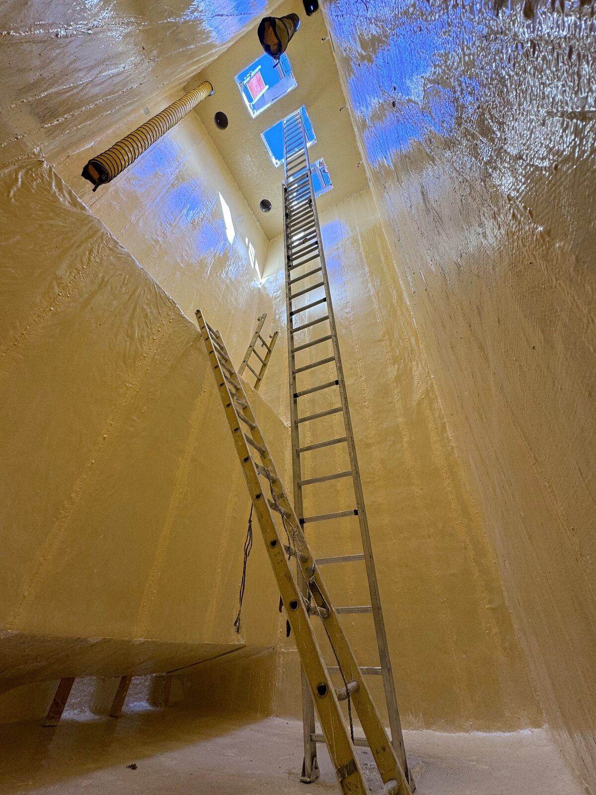 Inside a lined wet well, looking up toward the opening